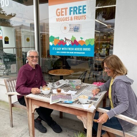 People enjoying breakfast at table outside Cafe